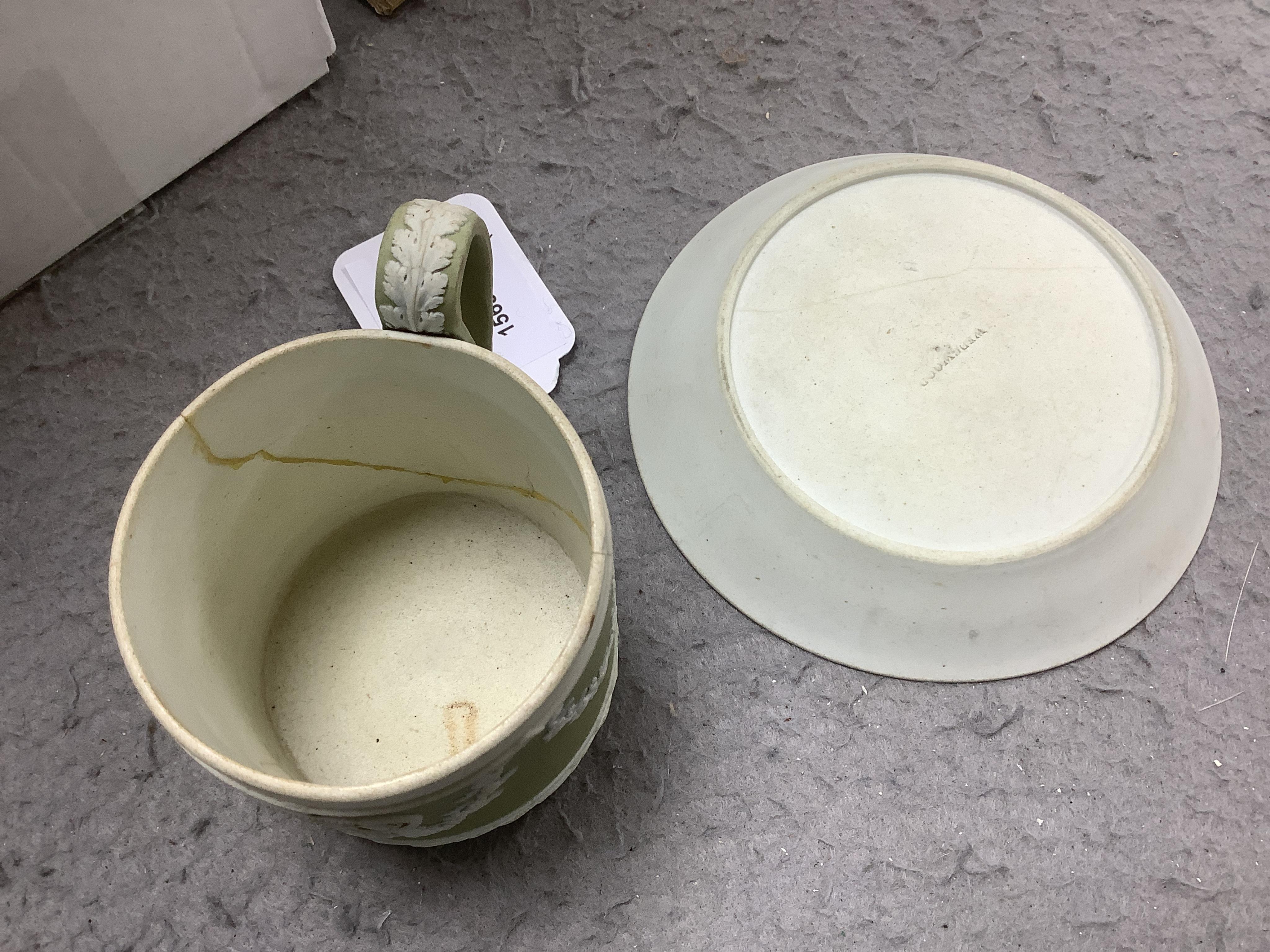 A Wedgwood three colour, green ground jasper cup and saucer and a single lilac ground saucer, early 19th century, 13.5cm. Condition - poor